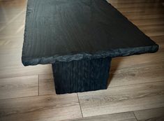 a wooden table sitting on top of a hard wood floor