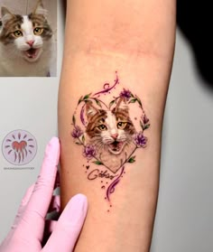 a cat with flowers on it's arm is shown next to a woman's hand