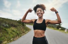 a woman flexing her muscles on the road