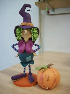 a figurine is standing next to a pumpkin