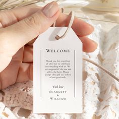 a person holding a welcome card in their hand