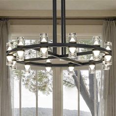 a chandelier hanging in front of a window