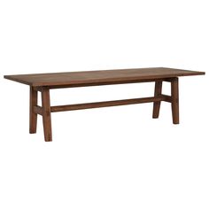 a large wooden table sitting on top of a white floor