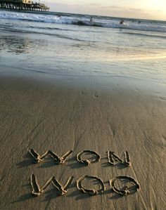 the word slow down written in sand at the beach