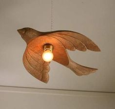 a bird shaped light hanging from the ceiling