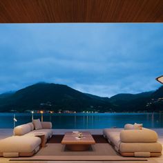 a living room filled with furniture next to a large body of water