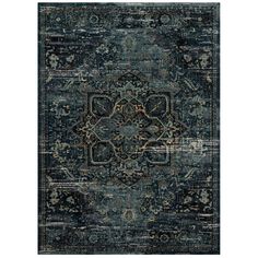 a blue rug with an ornate design on the front and back side, in various colors