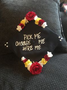 a black graduation cap with flowers on it that says pick me choose me where me