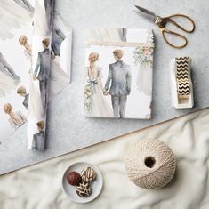 a table topped with pictures and yarn next to scissors