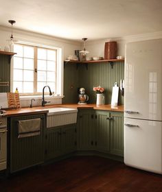 a white refrigerator freezer sitting inside of a kitchen