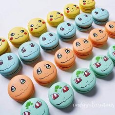 there are many macaroons with different faces on them, all lined up in the same row