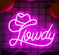 a neon sign that reads,'lovely'in white lettering on a purple background