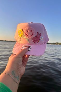 A Wild Bohemian exclusive! One of a kind, trucker hat with patches to match your own unique style! Adjustable snap back closure. Lightweight & breathable mesh back. Made with a durable foam material Pink Flat Bill Trucker Hat For Outdoor, Playful Pink Festival Hat, Pink Trucker Hat For Beach, Pink Trucker Hat For The Beach, Pink Adjustable Trucker Hat For Outdoor, Adjustable Pink Trucker Hat For Outdoor, Casual Pink Trucker Hat For Festival, Pink Summer Trucker Hat For Outdoor, Pink Summer Festival Trucker Hat