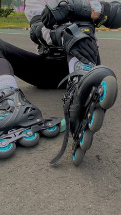 a person sitting on the ground with their feet in roller skates