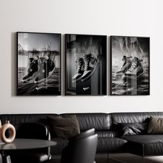 three black and white pictures hanging on the wall