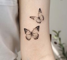 two small butterflies on the wrist tattoo design for girls and women, one is black and white