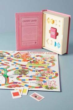 the candy land board game is open and ready to be played with its matching contents