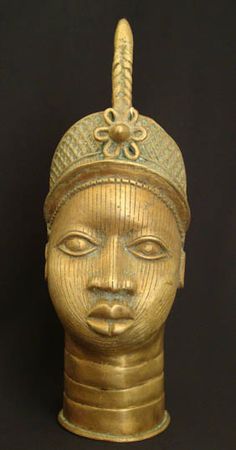 a gold head statue with a black background