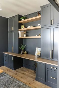 an office with gray cabinets and wooden floors