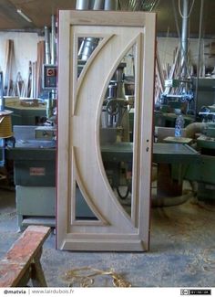 a wooden door is being worked on in a shop