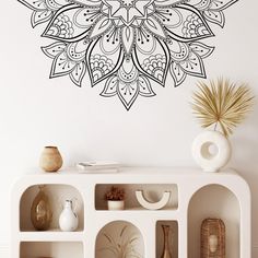 a decorative wall decal with an intricate design in black and white on the wall