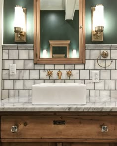 an instagram photo of a bathroom sink with two mirrors above it and lights on the wall