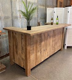 a wooden bar sitting in the middle of a room next to a wall with shutters