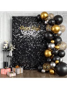 a black and gold party backdrop with balloons