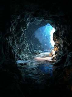 a dark cave with water coming out of it