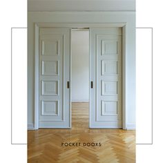 two white doors in an empty room with wood floors and parquet flooring on the side