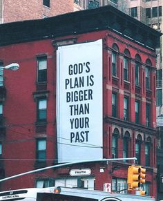 a large billboard on the side of a building that says god's plan is bigger than your past