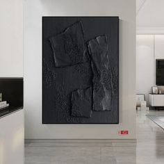 a black and white painting on the wall in a room