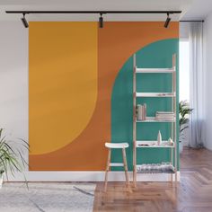 an orange, yellow and green wall mural in a living room with wooden flooring