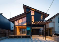 a house that is sitting in the middle of a street with lots of windows on it