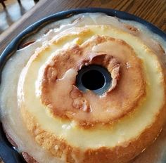 a bundt cake sitting on top of a pan covered in icing and cinnamon