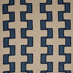 a blue and beige rug with wavy lines on it