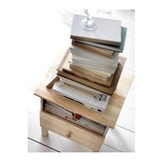 a stack of books sitting on top of a wooden table