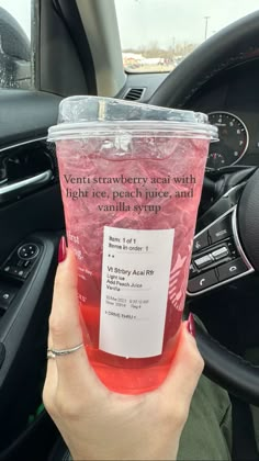 a person holding up a cup with pink liquid in it and the words, venti strawberry tea with light ice peach juice and only $ 9 99 per cup