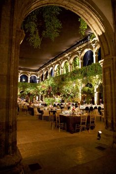 an indoor dining area with tables and chairs set up for formal function in the evening