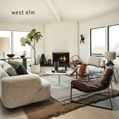 a living room filled with furniture and a fire place in the middle of a room