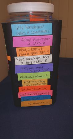 a cup with writing on it sitting on top of a table