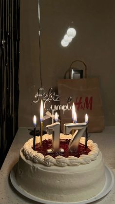 a birthday cake with lit candles and the number seventy