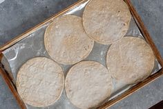 six tortillas sitting on top of a baking sheet