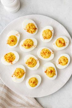 deviled eggs are arranged on a white plate