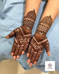 two hands with henna tattoos on them, one is showing the intricate design and the other has an ornate pattern