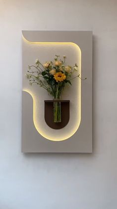 a vase filled with flowers sitting on top of a wall