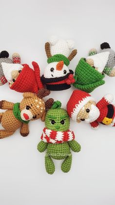 several crocheted stuffed animals are arranged in the shape of santa's helpers