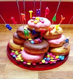 a birthday cake made out of donuts with candles