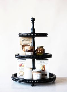 a three tiered tray with various items on it