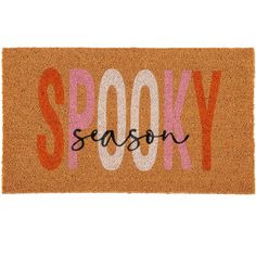 a door mat with the word spooky on it in white and orange letters